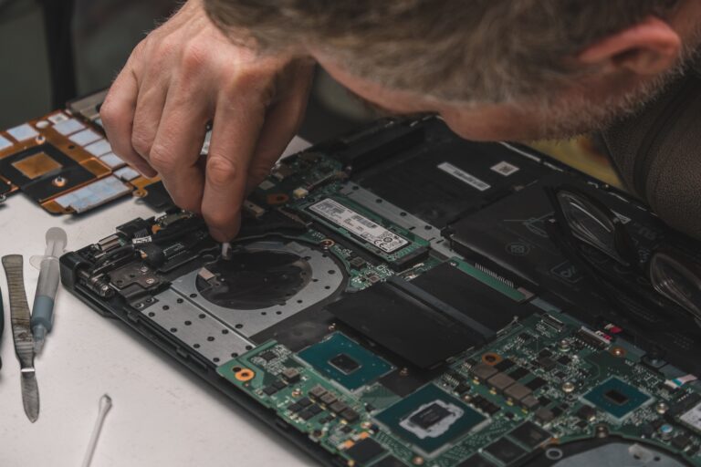 Laptop maintenance. Cleaning a part of the case at the location of the laptop cooling system.